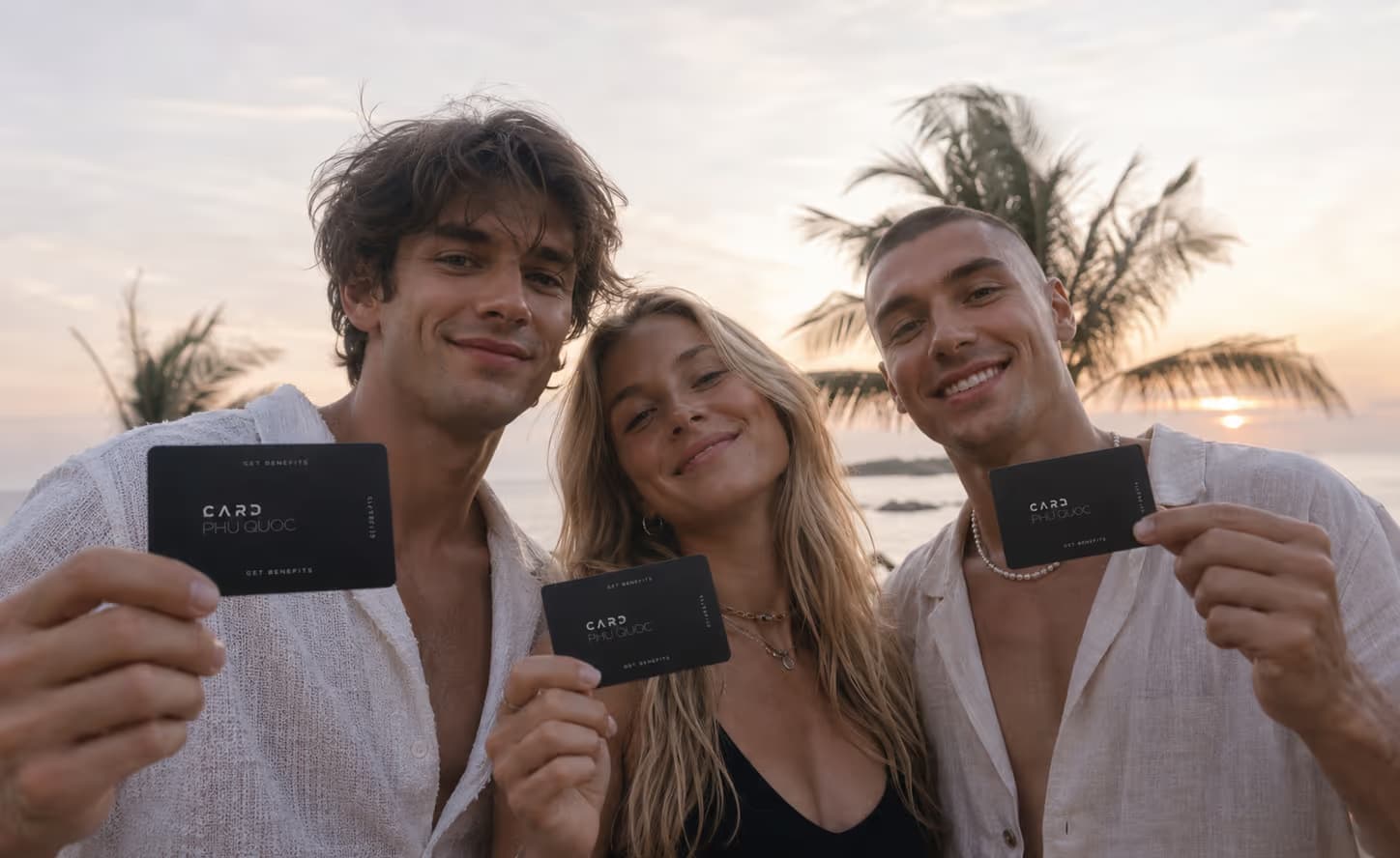 Friends on the beach holding their Card Phu Quoc cards