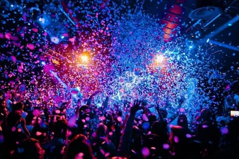 Confetti bursting over a dancing crowd in a Phu Quoc club